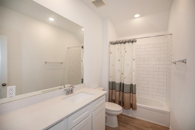 full bathroom with vanity, toilet, hardwood / wood-style floors, and shower / bath combo with shower curtain