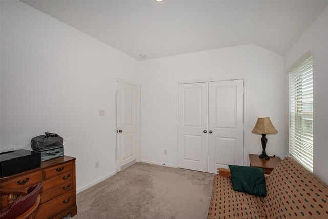 sitting room featuring lofted ceiling and light carpet