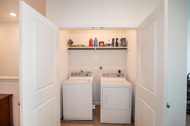 laundry room featuring independent washer and dryer and hardwood / wood-style flooring