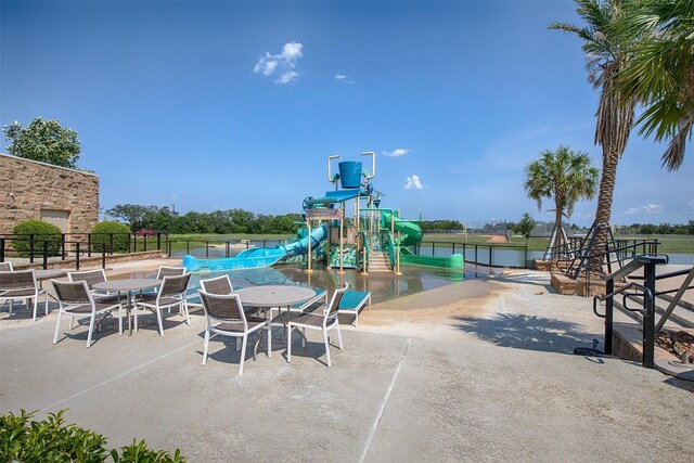 exterior space with a playground and a patio area