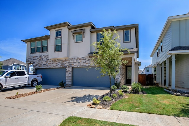 view of front facade featuring a garage and a front lawn