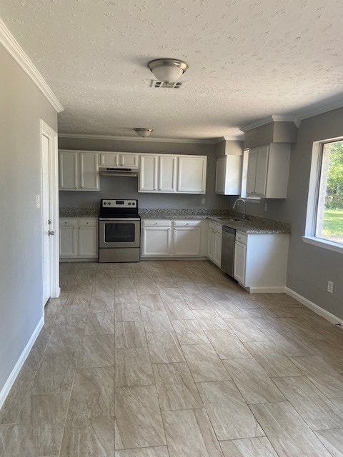 kitchen with light tile patterned flooring, range with electric cooktop, and stainless steel dishwasher