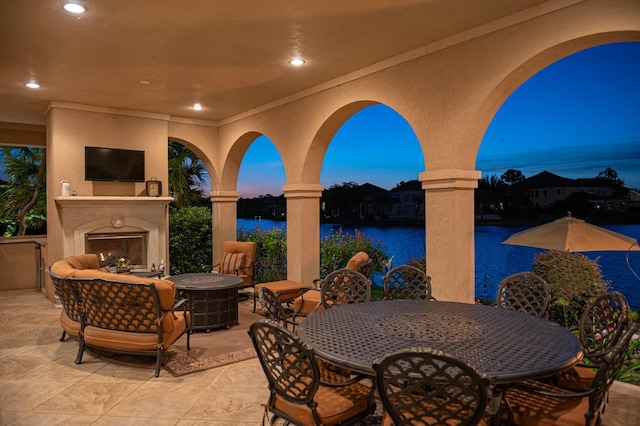 view of patio with outdoor dining space and a fireplace