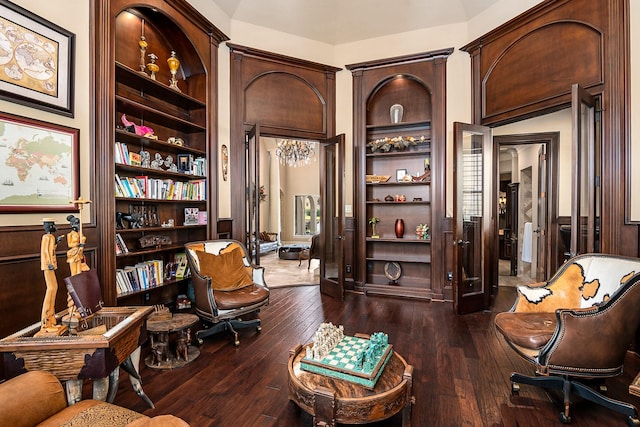 living area featuring dark wood-style floors and built in features