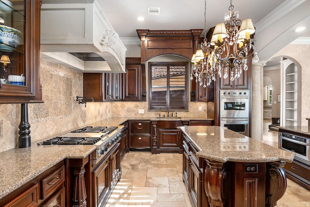 kitchen with stone tile flooring, arched walkways, appliances with stainless steel finishes, crown molding, and custom exhaust hood