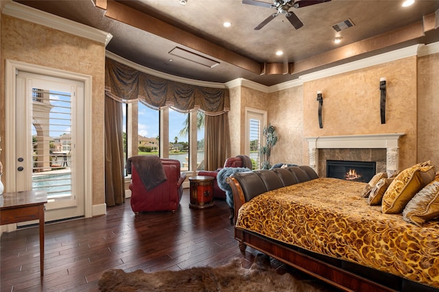 bedroom featuring visible vents, ornamental molding, access to exterior, wood-type flooring, and a raised ceiling