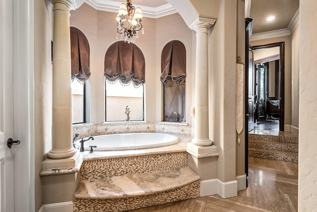 full bath with decorative columns, a garden tub, ornamental molding, and a notable chandelier