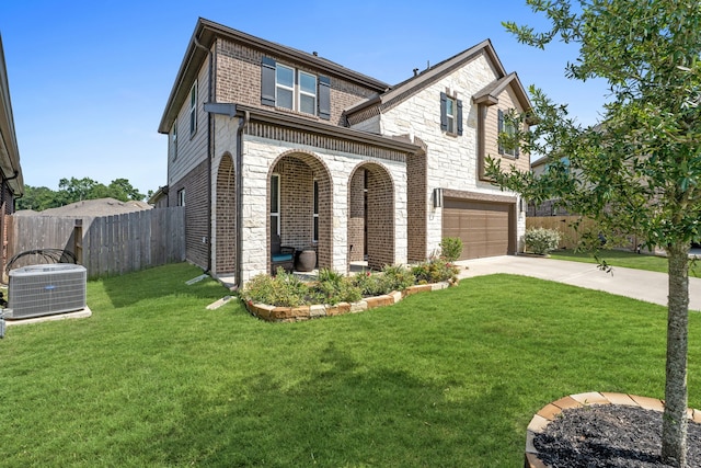 view of front of home featuring cooling unit, fence, concrete driveway, a front lawn, and a garage