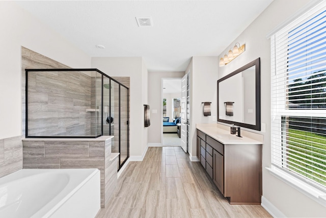 bathroom with plus walk in shower and vanity