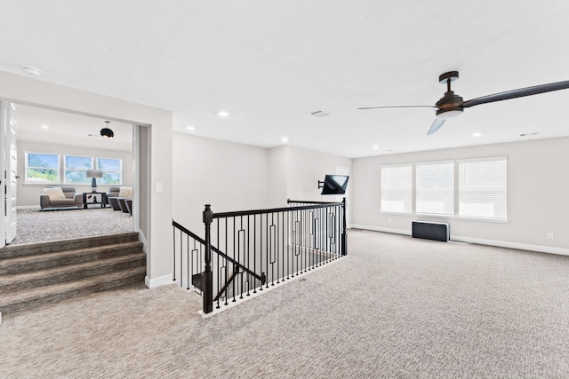 corridor with an upstairs landing, recessed lighting, baseboards, and carpet floors