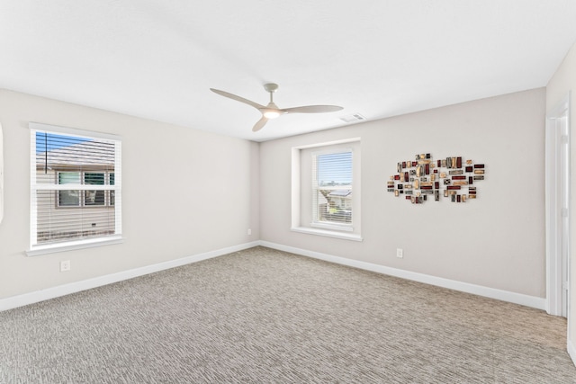 carpeted empty room featuring ceiling fan