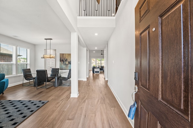 entryway featuring recessed lighting, baseboards, and light wood finished floors