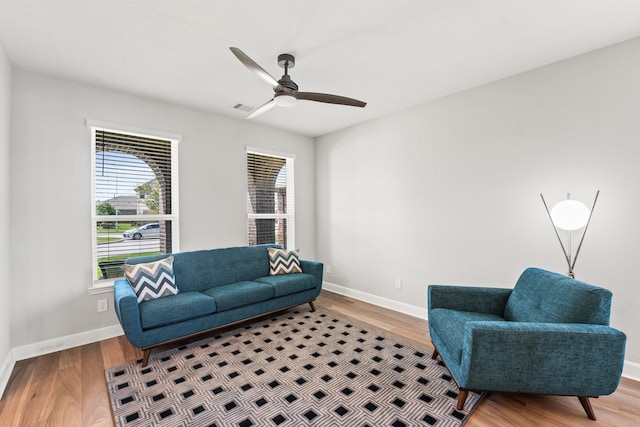 living room with ceiling fan and hardwood / wood-style flooring