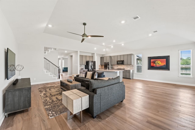 living room featuring hardwood / wood-style flooring and ceiling fan