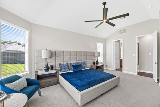 bedroom featuring ensuite bath, ceiling fan, vaulted ceiling, and wood-type flooring