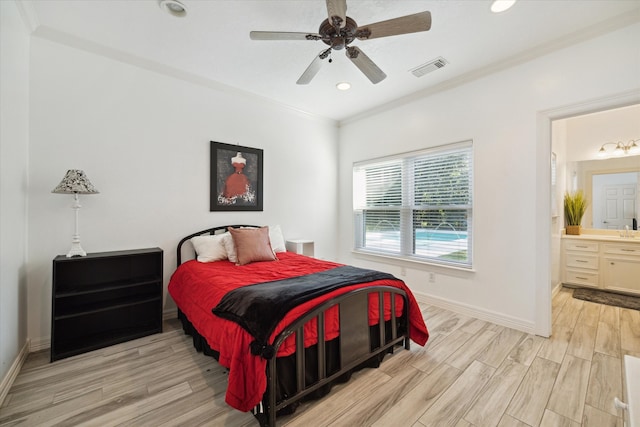 bedroom with ensuite bathroom, light hardwood / wood-style flooring, ceiling fan, and crown molding