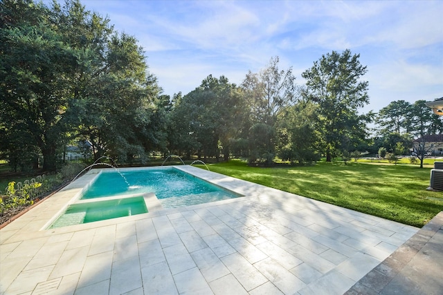 view of pool with pool water feature, an in ground hot tub, a patio, and a lawn