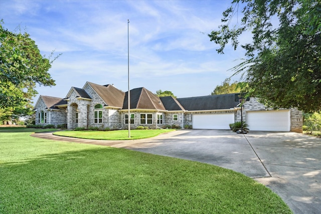 ranch-style house featuring a front lawn and a garage