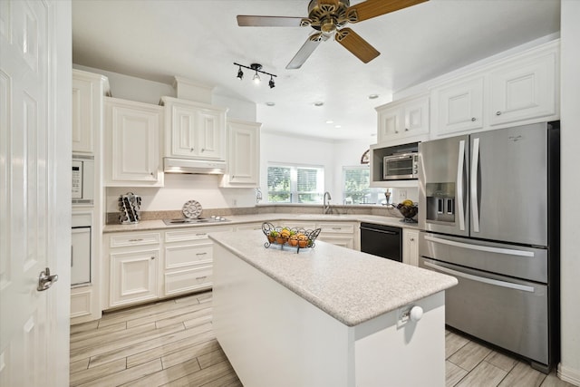 kitchen featuring white cabinets, a center island, and black appliances