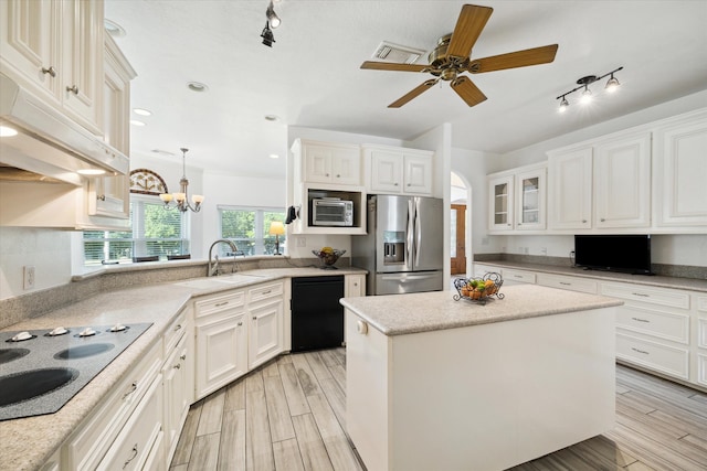 kitchen with light hardwood / wood-style flooring, electric cooktop, stainless steel fridge with ice dispenser, black dishwasher, and a kitchen island