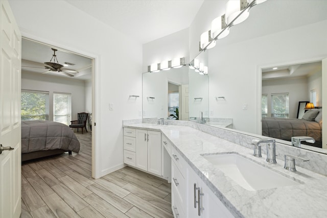 bathroom featuring ceiling fan, hardwood / wood-style floors, and vanity