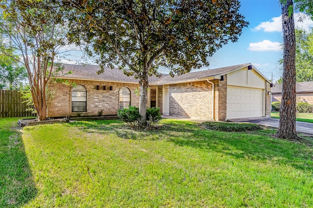 single story home with a front yard and a garage