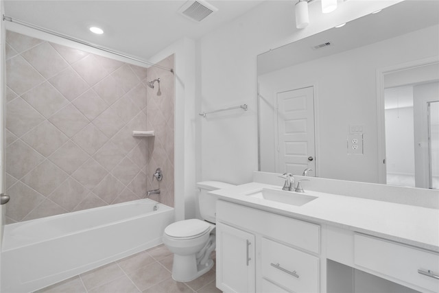 full bathroom with toilet, vanity, tiled shower / bath, and tile patterned floors