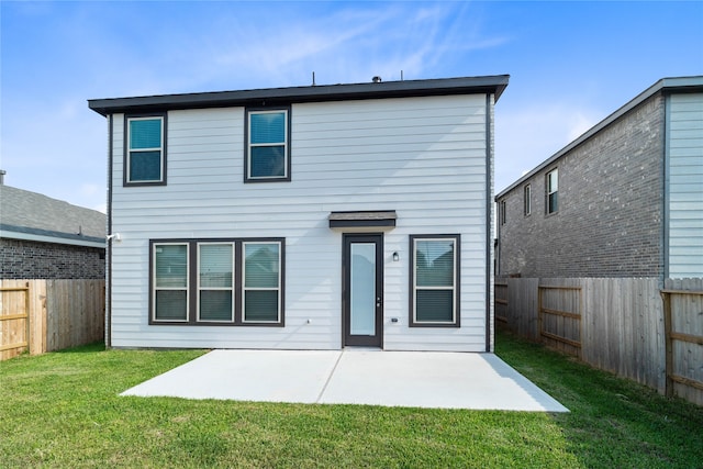 back of property featuring a lawn and a patio