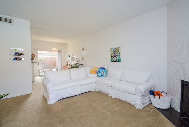 living room featuring a fireplace and carpet floors