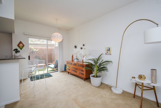 interior space featuring a chandelier and light carpet