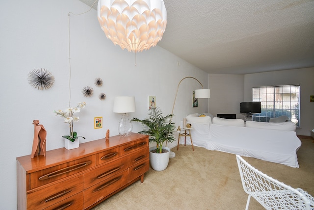 carpeted living room featuring a textured ceiling and a notable chandelier