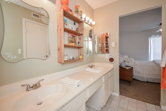 bathroom with ceiling fan, tile patterned flooring, a textured ceiling, and vanity