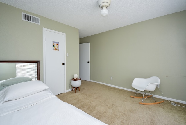 carpeted bedroom with a textured ceiling