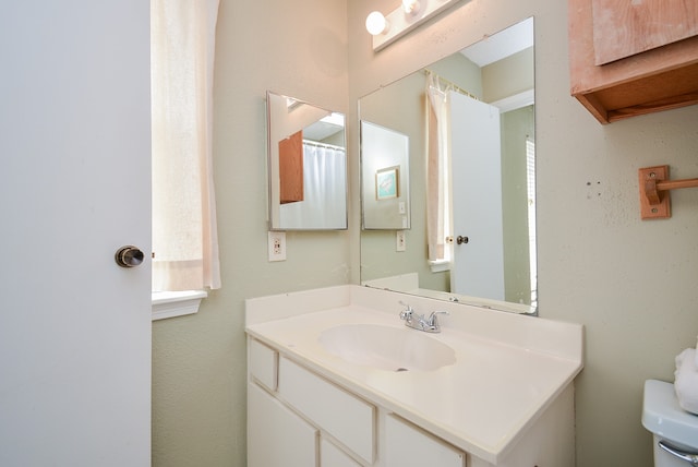 bathroom featuring toilet and vanity