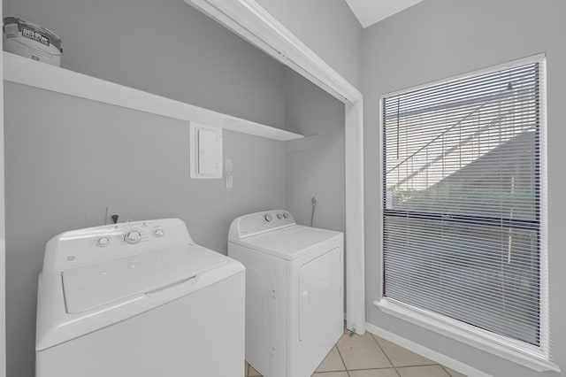 washroom with independent washer and dryer and light tile patterned floors