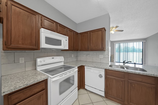 kitchen featuring sink, light stone counters, white appliances, tasteful backsplash, and ceiling fan