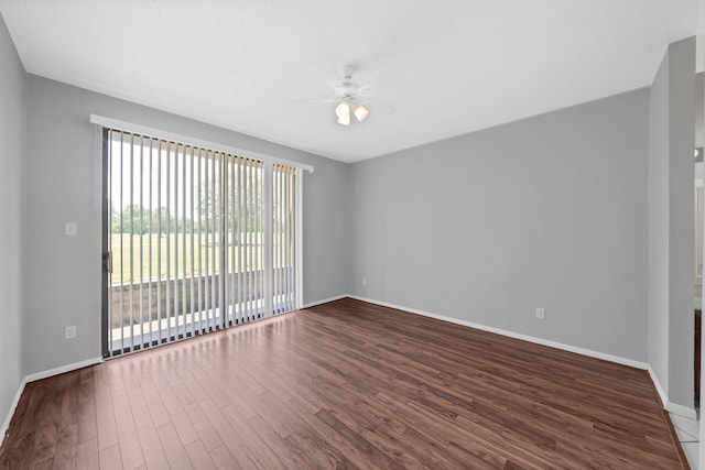 spare room with ceiling fan, a healthy amount of sunlight, and wood-type flooring