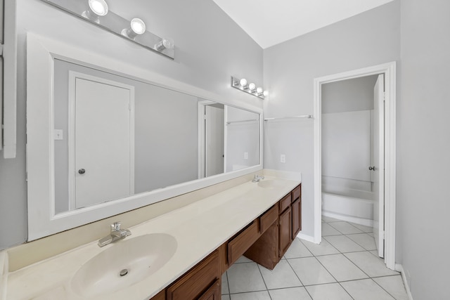 bathroom with tile patterned flooring, shower / washtub combination, and vanity