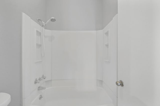 bathroom with toilet and shower / washtub combination