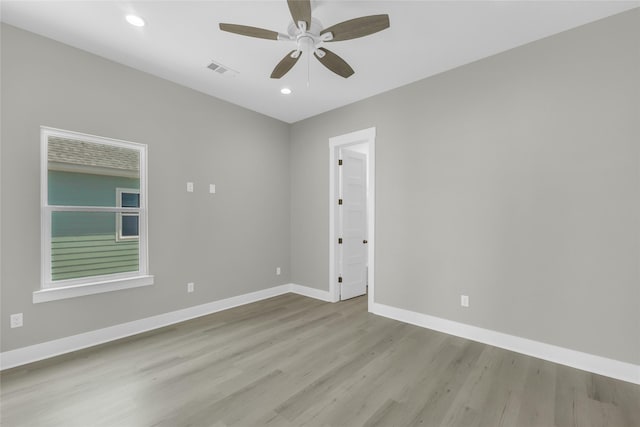 empty room featuring recessed lighting, visible vents, light wood finished floors, and baseboards