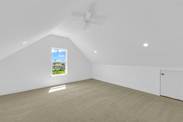 bonus room featuring baseboards, vaulted ceiling, and light colored carpet