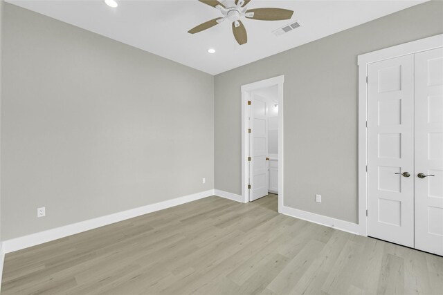 unfurnished bedroom with ceiling fan, connected bathroom, light hardwood / wood-style flooring, and a closet