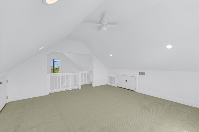 additional living space with ceiling fan, carpet floors, and vaulted ceiling