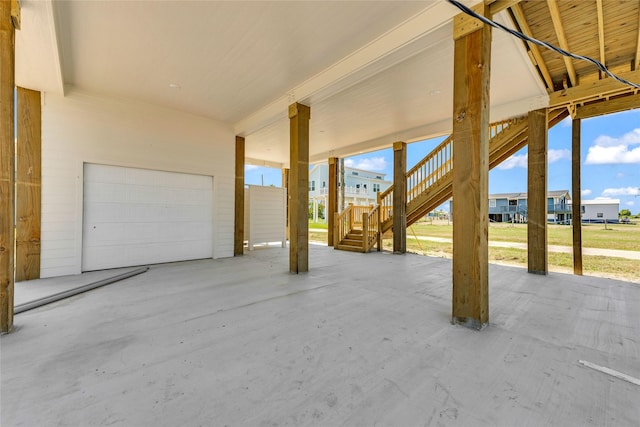 view of patio with a garage and stairway