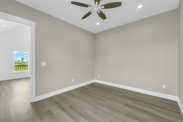 unfurnished room with recessed lighting, baseboards, and wood finished floors