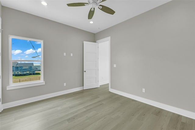 empty room featuring ceiling fan and light hardwood / wood-style floors