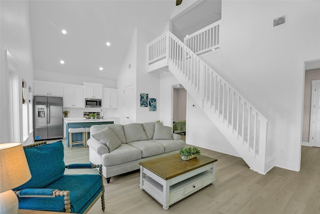 975 Alberdie Dr, Crystal Beach, TX 77650 - living area featuring high vaulted ceiling, stairs, light wood-style floors, recessed lighting, and baseboards