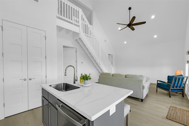 975 Alberdie Dr, Crystal Beach, TX 77650 - kitchen featuring a sink, dishwasher, ceiling fan, light wood finished floors, and open floor plan
