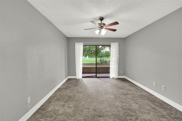 tiled empty room featuring ceiling fan and a textured ceiling