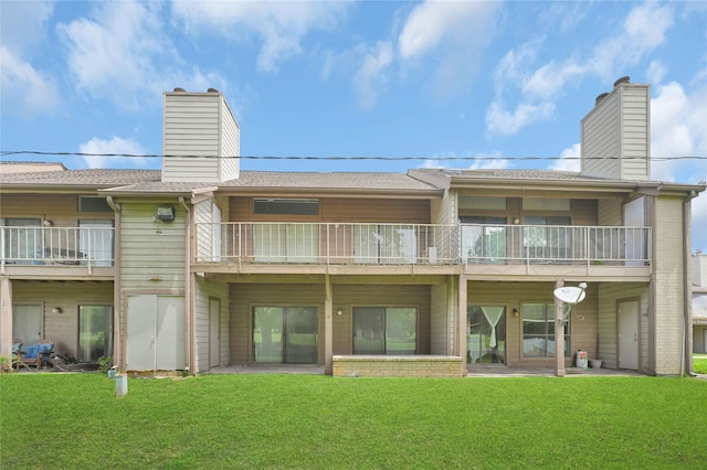 exterior space with a yard and a balcony